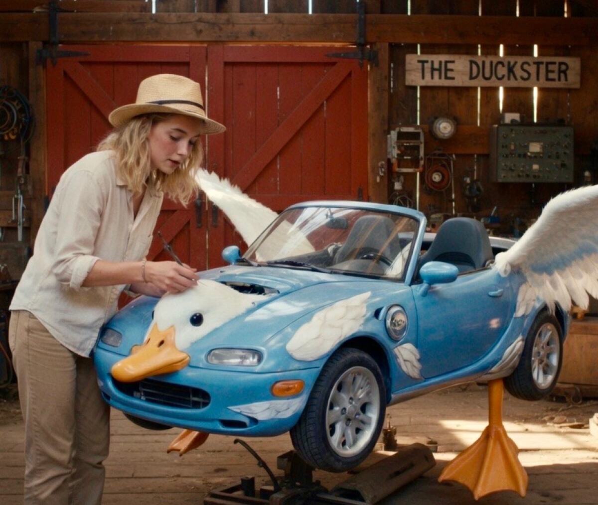 Dolly fitting Duckster in the barn under the Duckster sign